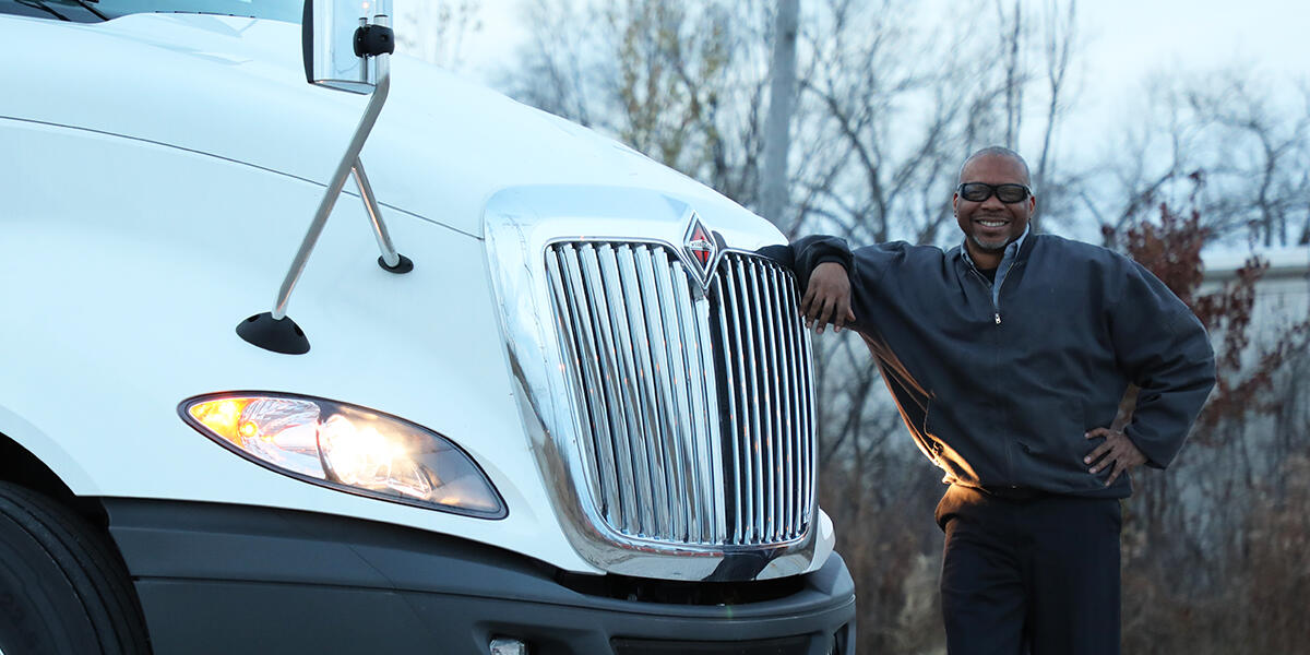 Driver standing next to his International LT