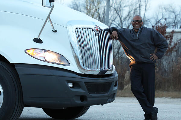 Driver standing next to his International LT